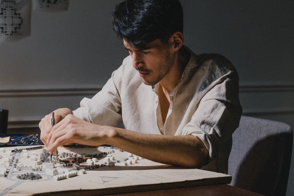 An architect working on a detailed architectural model