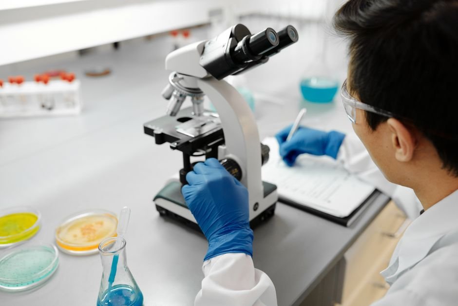 Researcher using a microscope at a top university in USA for materials science